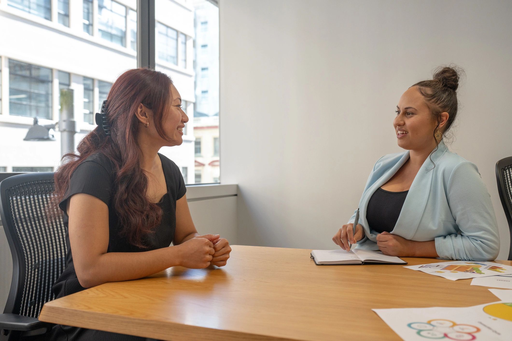 Two colleagues discussing ideas in a meeting