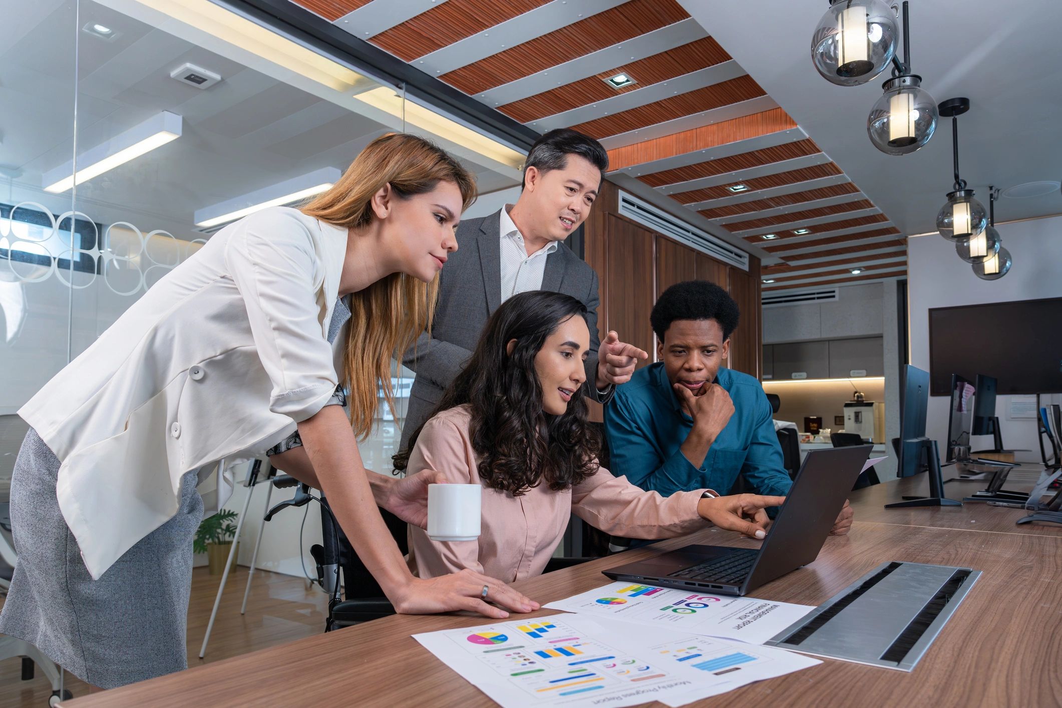 Colleagues collaborating around a table during a hiring discussion